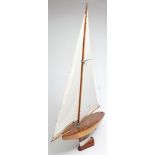 A model pond yacht, circa 1940's:, fully rigged over a laminated hull with shaped weighted keel,