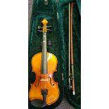 A modern student three quarter size violin: the two piece back of medium flame and curl,