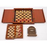 An early 20th century mahogany folding chess set with turned ivory pieces and one other smaller:,