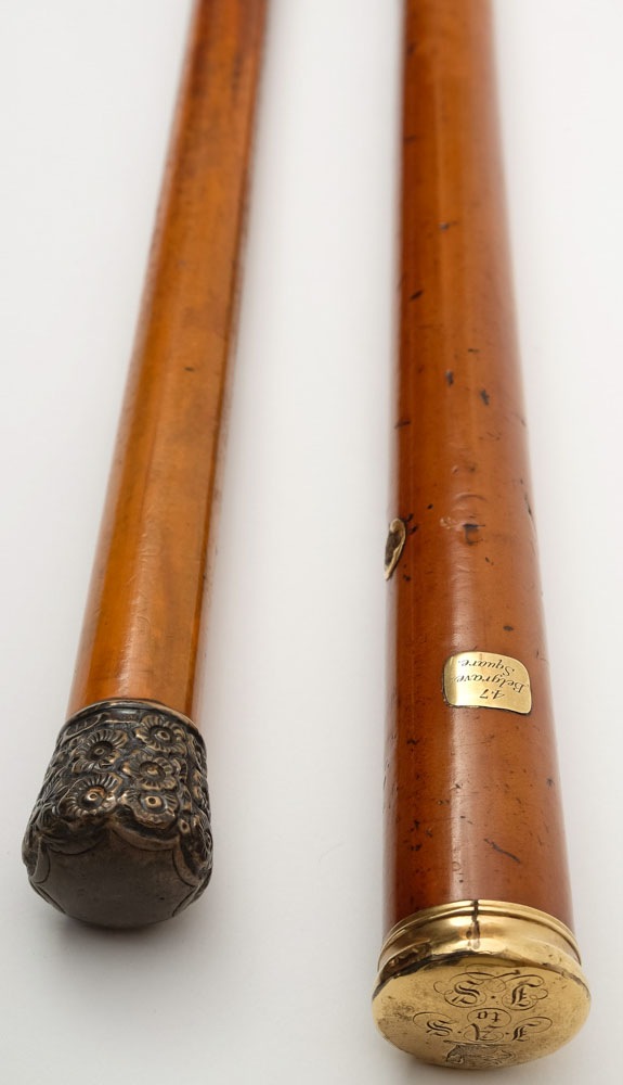 A Georgian yellow metal mounted walking cane together with a similar later silver mounted example:,