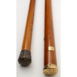 A Georgian yellow metal mounted walking cane together with a similar later silver mounted example:,