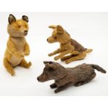 A blonde plush fox by Steiff, together with two similar dogs:, the former with glass eyes,