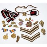 A collection of various military buttons and badges together with two WWI Victory medals:,