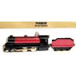 A Markie O gauge 4-4-0 live steam locomotive and tender:, in black and red livery in original box.