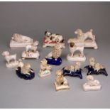 A group of twelve various Staffordshire porcelain poodles and a spaniel: modelled in various poses