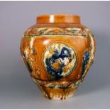 A Chinese sancai glazed pottery jar: in Tang style, moulded in relief with dragon medallions,