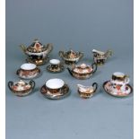 A Royal Crown Derby miniature porcelain tea service and one other: comprising a teapot and cover,