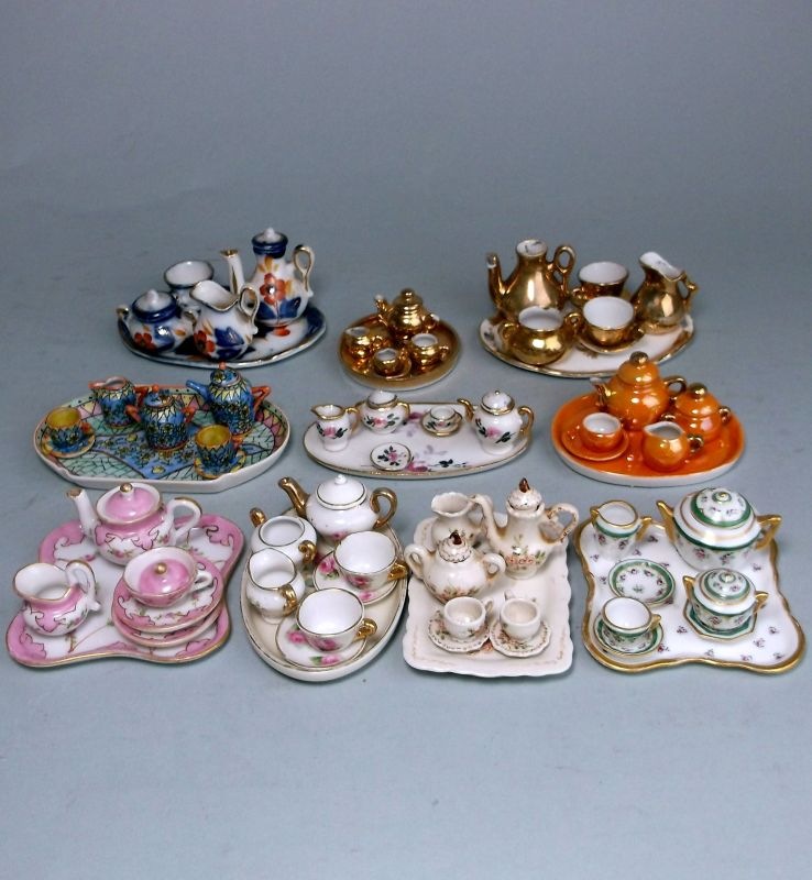 Ten various miniature porcelain cabaret sets: including three with gold or orange lustre decoration,