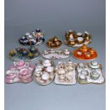 Ten various miniature porcelain cabaret sets: including three with gold or orange lustre decoration,