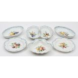 A Meissen porcelain dessert service: each piece enamelled with fruit and cut fruit within blue and