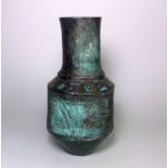 An early Troika pottery urn: under oxidised and glossy glazes on a textured ground,