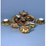 A Coalport porcelain miniature fruit painted tea set and a similar Caverswall example: the former