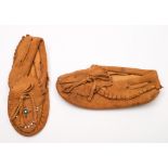 A pair of North American Native child's leather moccasins with traditional beadwork decoration:.