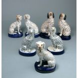 Three pairs of Staffordshire and later Dalmatians and one other: each in seated posture on oval