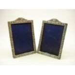 A pair of George V silver scroll decorated picture frames, Birmingham 1927:, 18.5cm high.