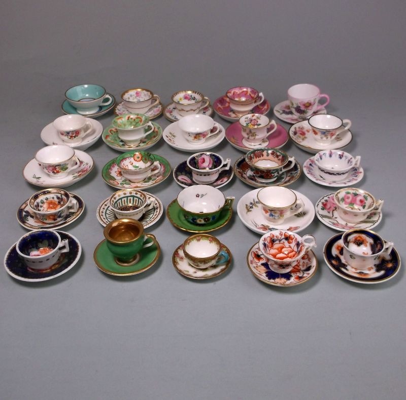 A group of twenty five miniature porcelain cups and saucers: including Shelley, Foley,