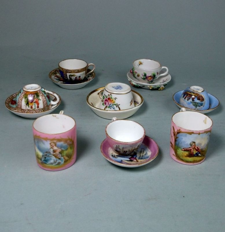 Six Continental porcelain miniature cups and saucers: and two miniature mugs, variously decorated,