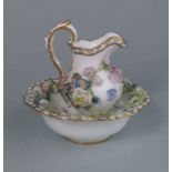 A Meissen miniature porcelain jug and basin: each applied with flowers and foliage,
