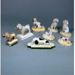 A group of eight porcelain dog figures: comprising a pair of Samuel Alcock seated poodles and two
