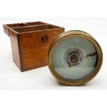 A brass plated circular cased pigeon racing clock:, numbered 26742, in an oak case, 17cm diameter.