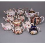 A group of teapots and kettles: comprising a Meissen flower encrusted teapot,