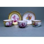 Two miniature Meissen cups and saucer and a further cup: one painted with garden flowers within a