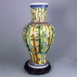 A Japanese porcelain baluster vase: painted with birds and insects amongst bamboo on a yellow