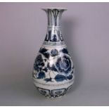 A Chinese blue and white bottle vase: in Yuan Dynasty style, painted with peony,