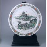 A large Chinese porcelain famille verte dish: of circular shallow form enamelled with an extensive