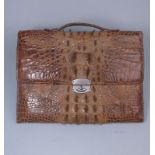 A Ladies crocodile skin slip case: with carrying handle and leather lined interior the metal clasp