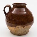 A Oriental brown and green glazed pottery vase and a brown glazed jug: the first of baluster form,