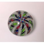 A John Deacons glass paperweight: set with a central cluster of canes with radiating colourful