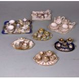 Four miniature Limoges porcelain cabaret sets and three others: the former on oval trays and