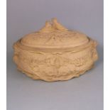 A large Wedgwood cane ware pie dish and cover: of oval form the dish embossed in high relief with