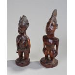 Two African figures, the first a female figure carved with geometric line body decoration, beads