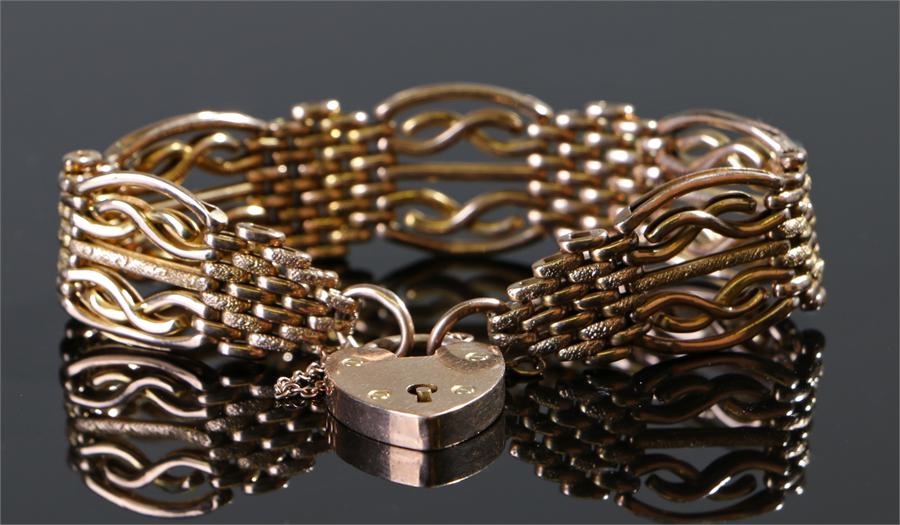 9 carat gold padlock bracelet, the padlock clasp with mesh and curved bar links, 23.9 grams