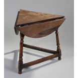 18th Century style drop leaf cricket table, the triangular top with three drop leaf sides, raised on