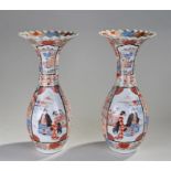 Pair of Meiji Japanese porcelain vases, the flared neck with polychrome decoration, a peacock, among
