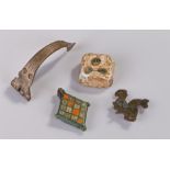 Mixed artefacts, to include a Roman dice, Romano British rider and horse brooch, a silver Roman