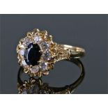 18 carat gold diamond and sapphire set ring, the central sapphire surround by eight diamonds to form