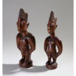 Near pair of male Yoruba figures, with line hair, ring turned bases, 30cm and 28cm high (2)