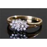 18 carat gold diamond set ring, the oval flower head diamond set design with splayed shank, ring