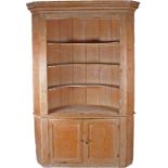 19th Century pine corner cabinet, with a concave cornice above a Greek key frieze, barrel back three