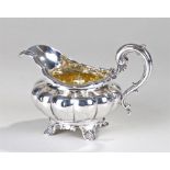 George III silver jug, marks rubbed, with gilded interior, gadrooned bulbous base, scroll handle,