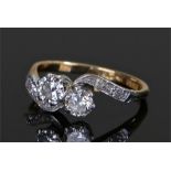 18 carat gold diamond ring, the cross over diamonds with diamonds to the shoulders set on platinum