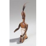 Bone and carved wood Tribal figure, with tall hair, long face, movable arms and legs, 20cm high