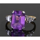 18 carat gold, amethyst and diamond set ring, the emerald cut amethyst flanked to the platinum