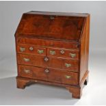 18th Century walnut bureau, the rectangular top above a sloping fall enclosing pigeon holes and