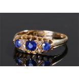 18 carat gold sapphire and diamond ring, with a row of three sapphires and four diamonds, ring