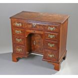George II style walnut kneehole desk, the rectangular top with a long drawer above seven drawers